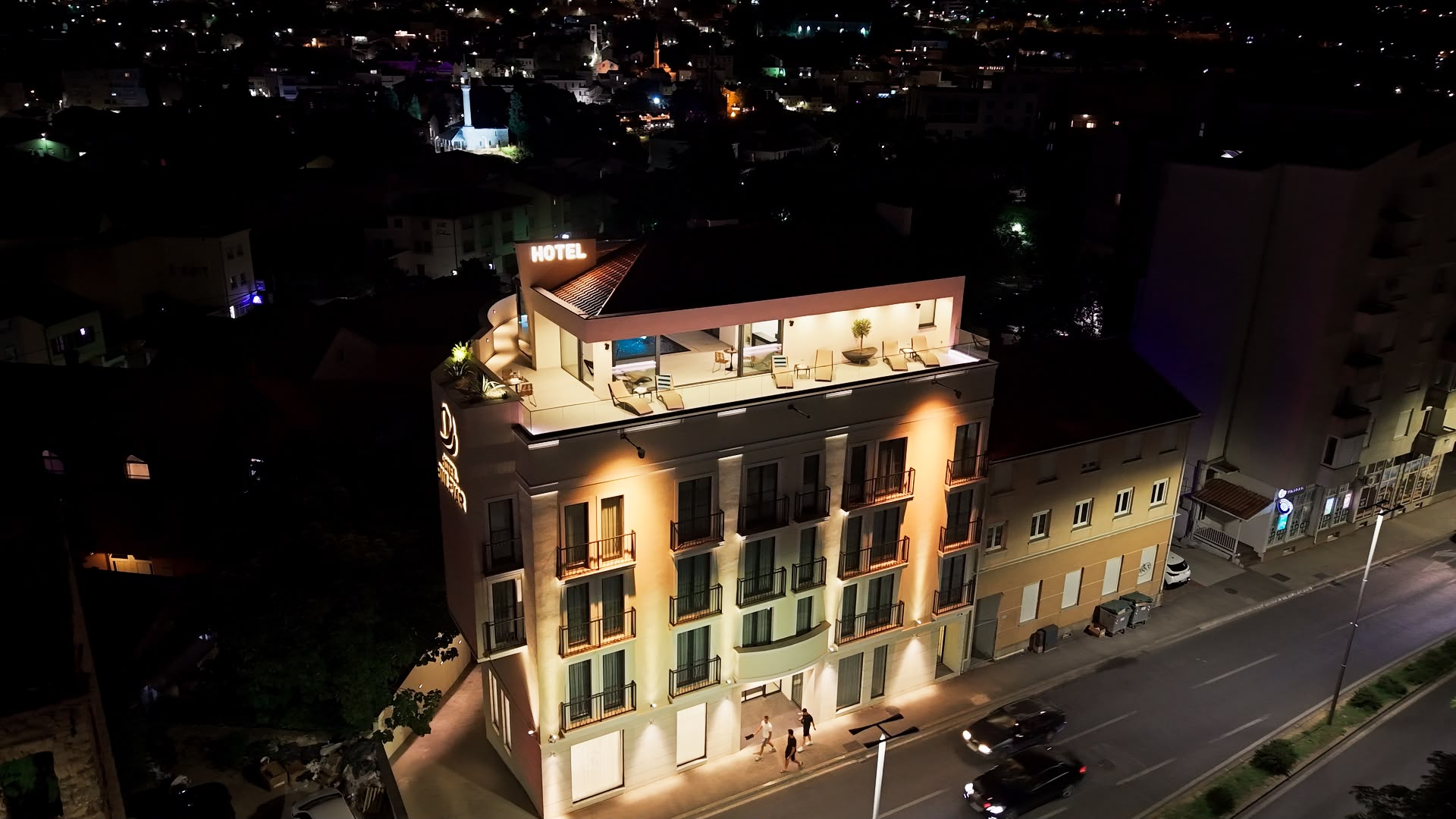 Hotel Bulevar's rooftop terrace and pool, lit at night, ahead of a live music evening